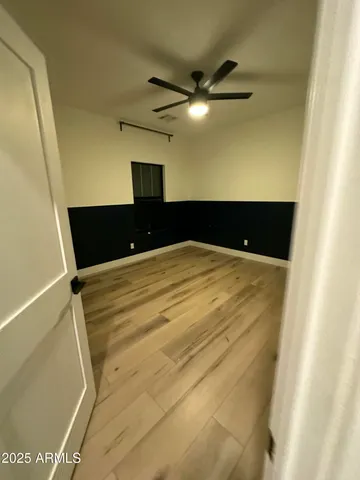 a bedroom with a bed and a ceiling fan