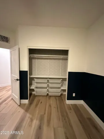 a view of walk in closet with empty racks