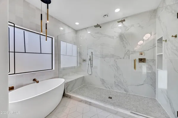 a bathroom with a bathtub and a shower