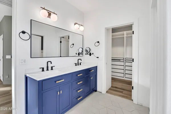 a bathroom with a double vanity sink and mirror