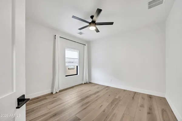 wooden floor in an empty room with a window