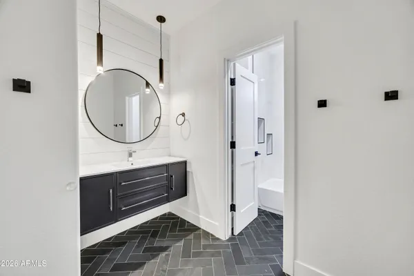 a bathroom with a sink a mirror and a shower