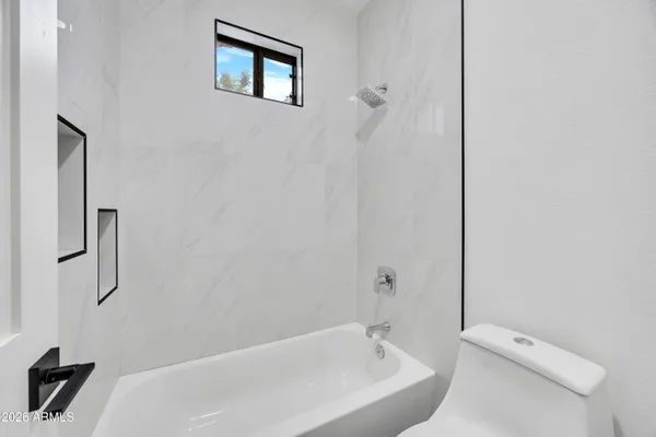 a bathroom with a bathtub and shower