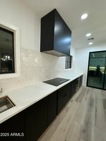 a large kitchen with kitchen island a refrigerator a sink dishwasher a dining table and chairs