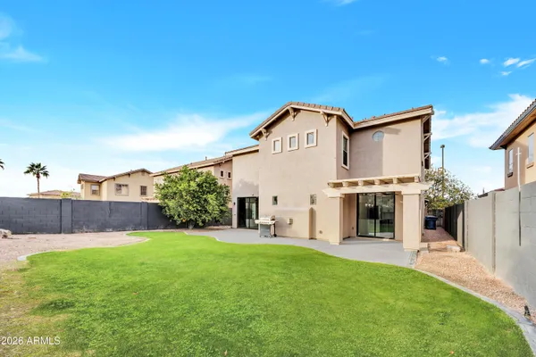a view of a house with a yard and sitting area
