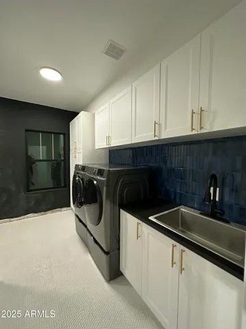 a view of an empty room with wooden floor and a ceiling fan