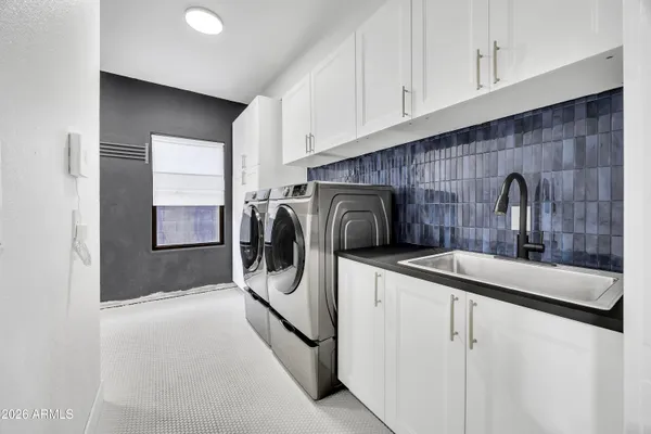 a kitchen with a sink and a washer dryer