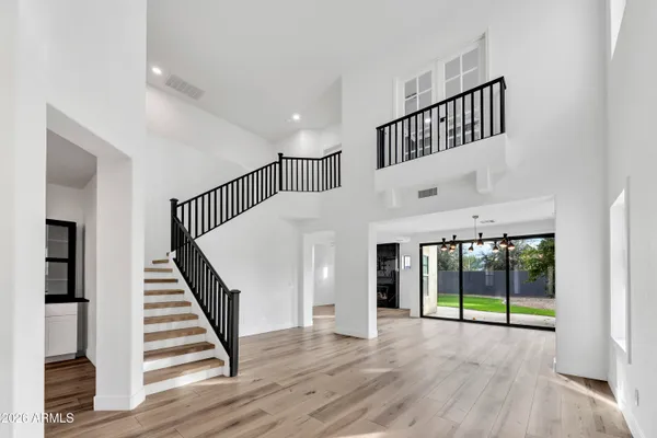 a view of staircase with wooden floor and white walls