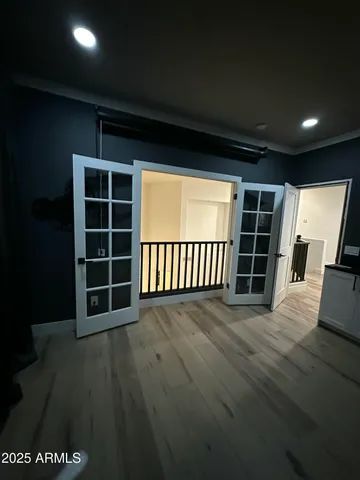 a view of empty room with wooden floor and windows