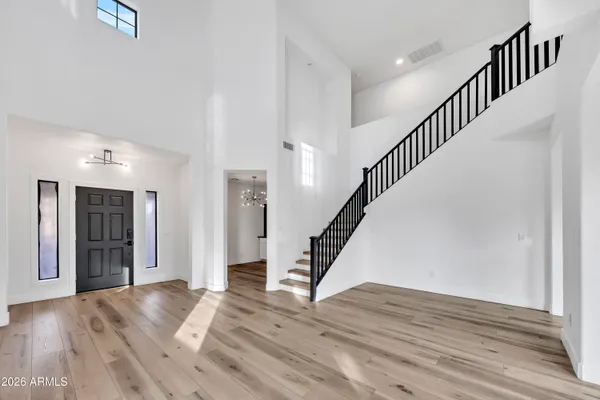 a view of entryway and hall with wooden floor