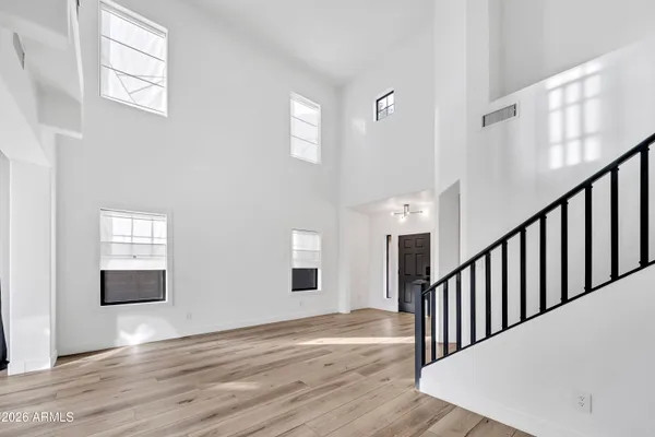 a view of a room with wooden floor and windows