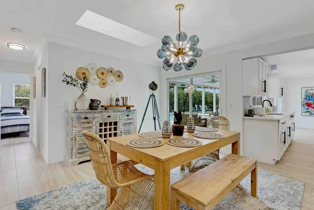 a view of a patio with table and chairs with wooden floor and fence