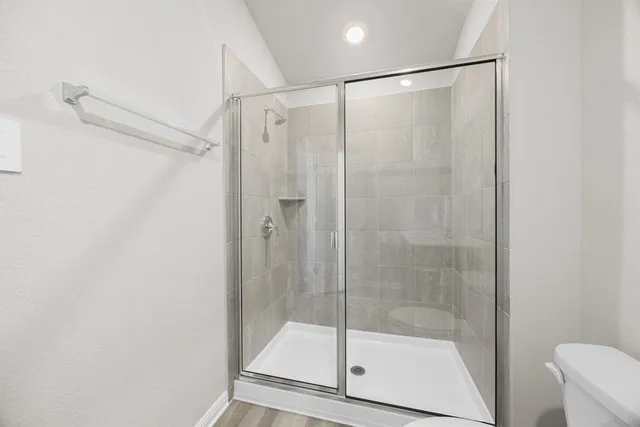 a bathroom with a glass door shower
