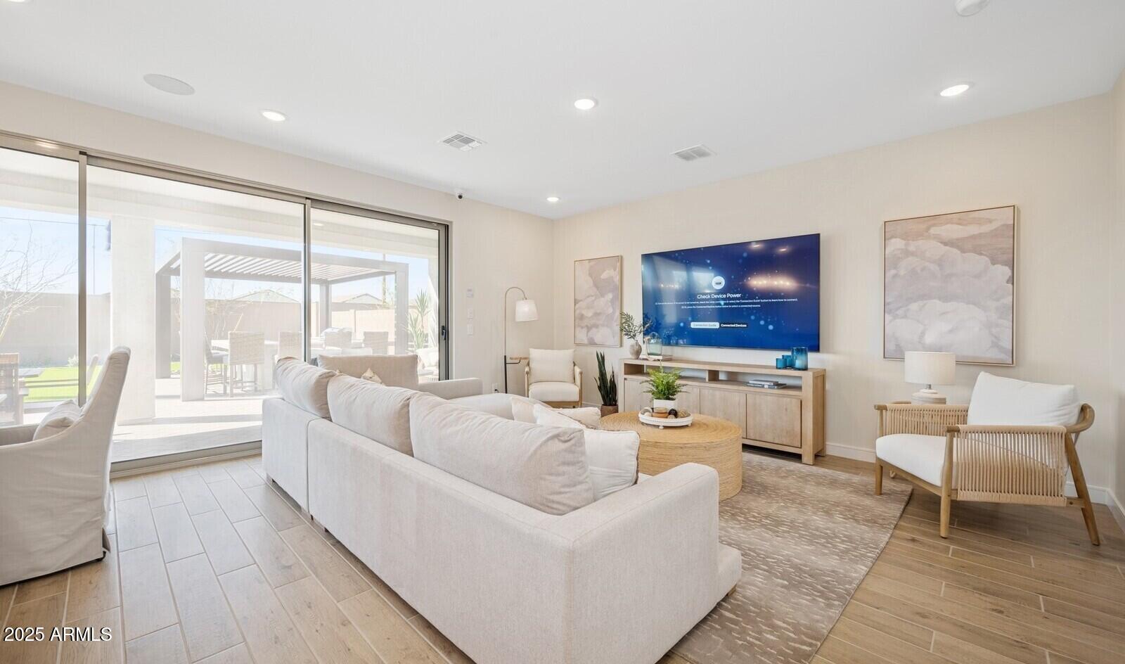 8026 West Royal Palm Road Peoria, AZ 85345 - Photo 9 of 37 a living room with furniture and a flat screen tv