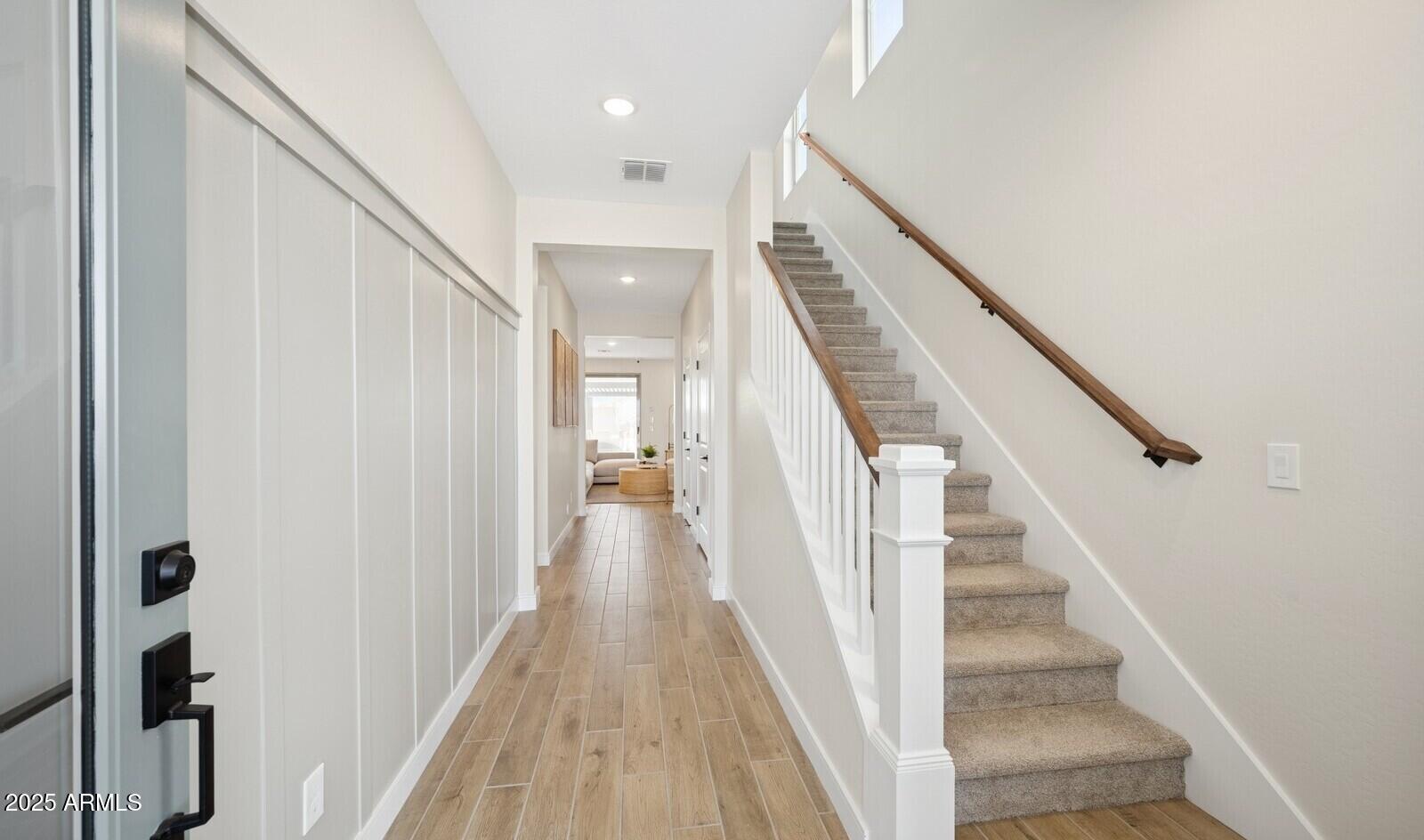 8026 West Royal Palm Road Peoria, AZ 85345 - Photo 18 of 37 a view of staircase with lots of frames on wall and wooden floor