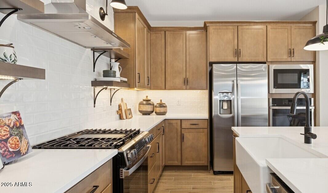 8026 West Royal Palm Road Peoria, AZ 85345 - Photo 5 of 37 a kitchen with a sink a stove and refrigerator
