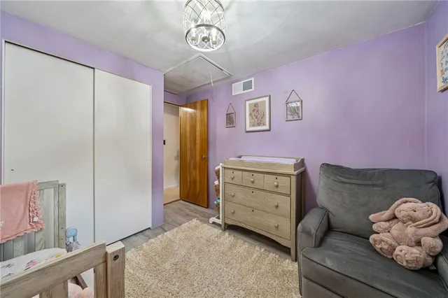 a bedroom with furniture and a dresser