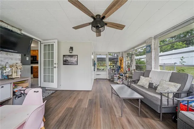 a living room with furniture and a wooden floor