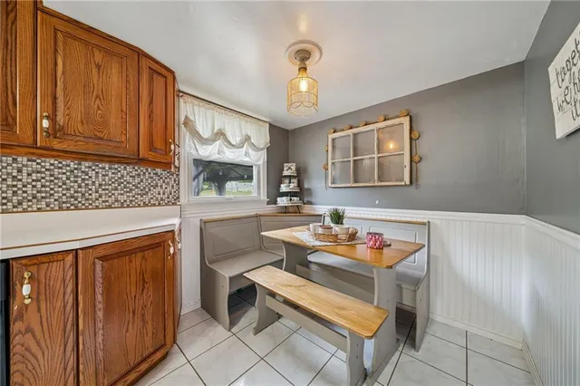a reading room with furniture a chandelier and a window