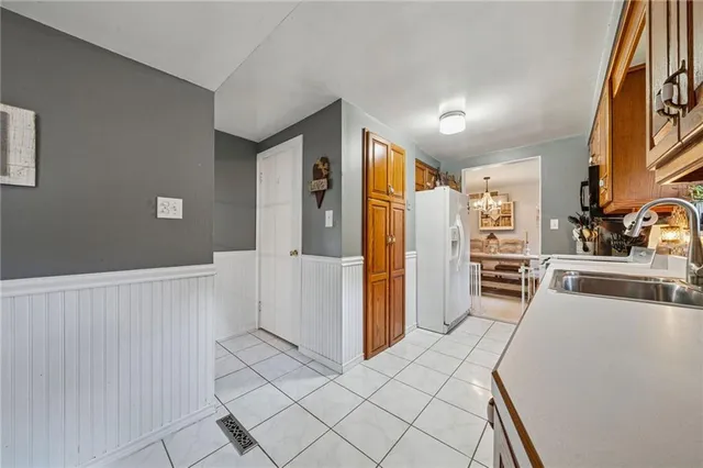 a kitchen with stainless steel appliances kitchen island granite countertop a refrigerator and a stove top oven