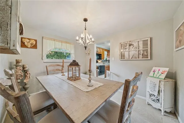 a view of a dining room with furniture and chandelier