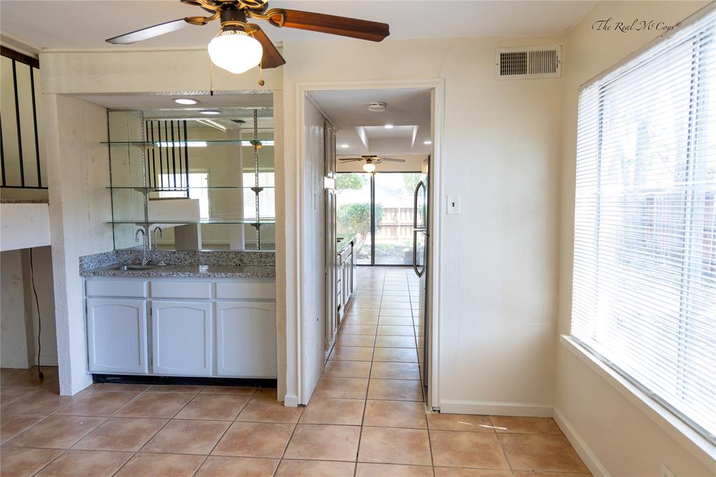 3101 Raintree Drive Plano, TX 75074 - Photo 4 of 17 Wet bar in the dining area, with a walk way to the kitchen.