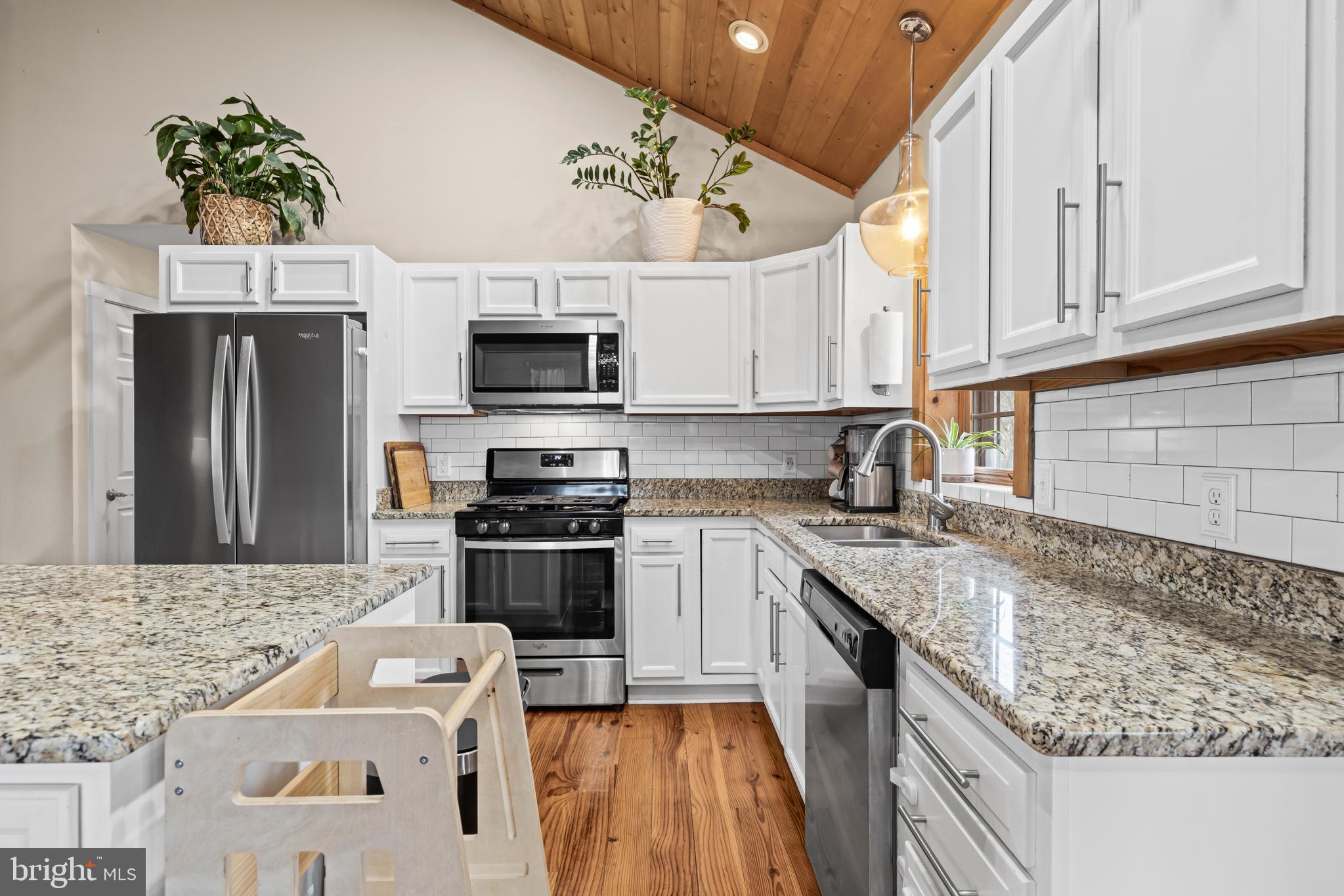 4112 Jacks Shop Road Rochelle, VA 22738 - Photo 12 of 54 a kitchen with granite countertop a sink stainless steel appliances and white cabinets