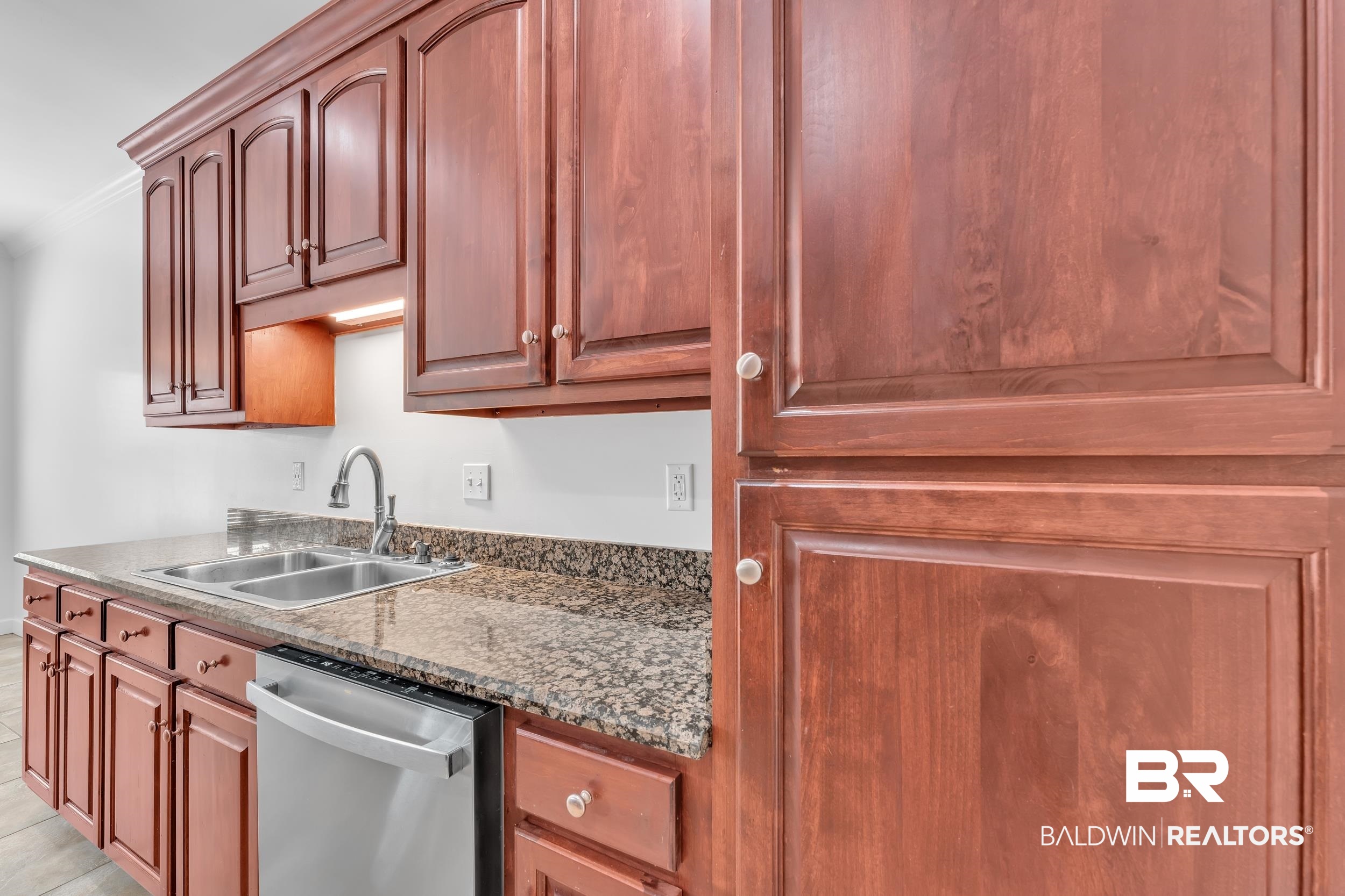 9508 Collier Loop Daphne, AL 36526 - Photo 18 of 29 Kitchen with stainless steel dishwasher, a sink, and stone counters