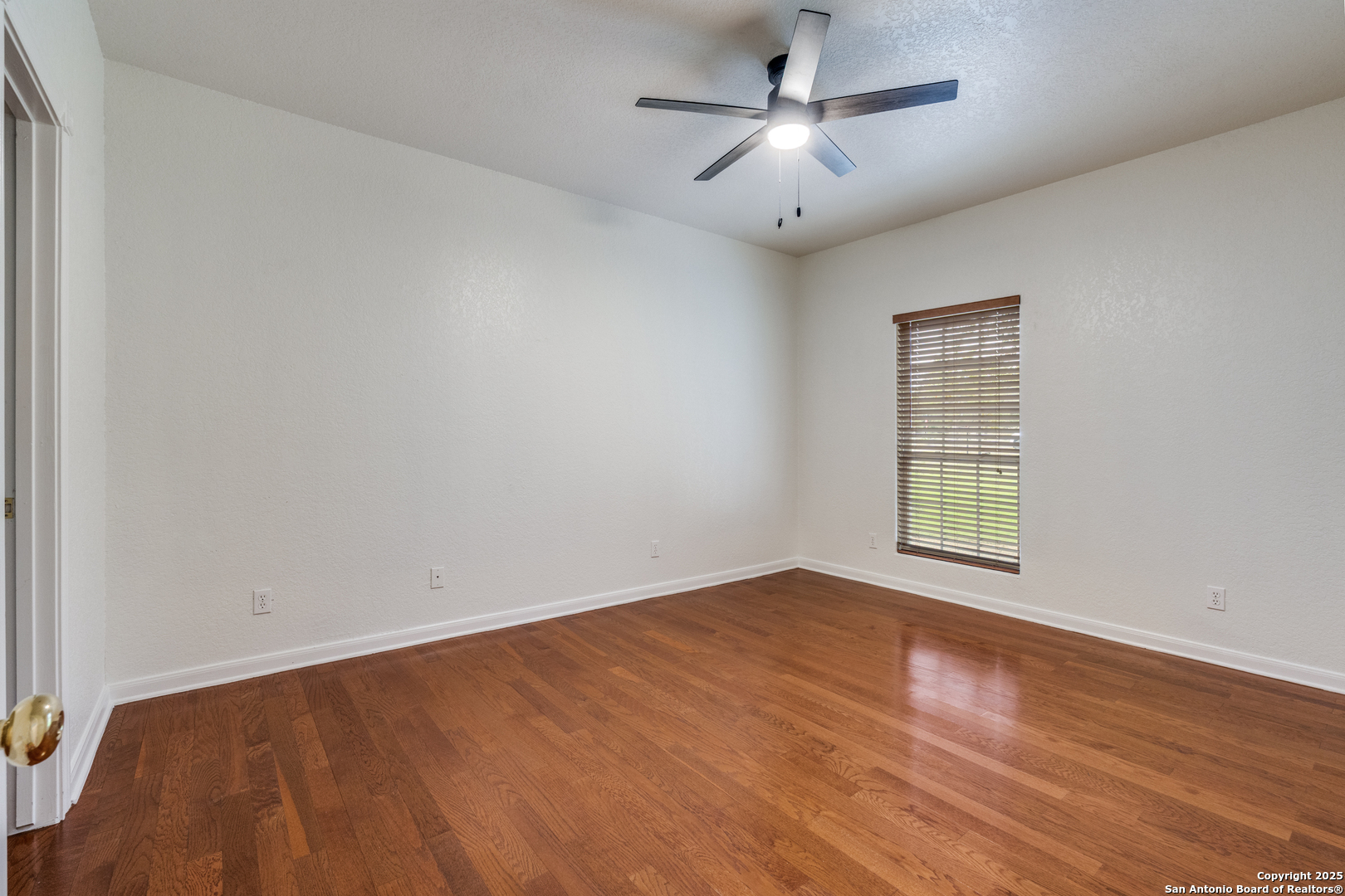 201 Yucca Canyon Spring Branch, TX 78070 - Photo 18 of 40 wooden floor in an empty room with a window