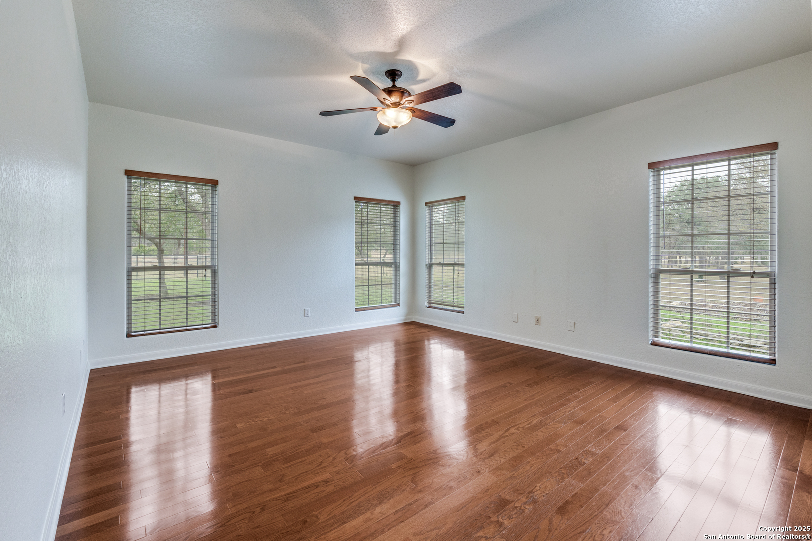 201 Yucca Canyon Spring Branch, TX 78070 - Photo 7 of 40 a view of an empty room with wooden floor and a window