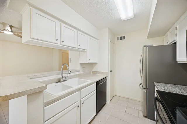 a kitchen with stainless steel appliances cabinets a sink and a counter space
