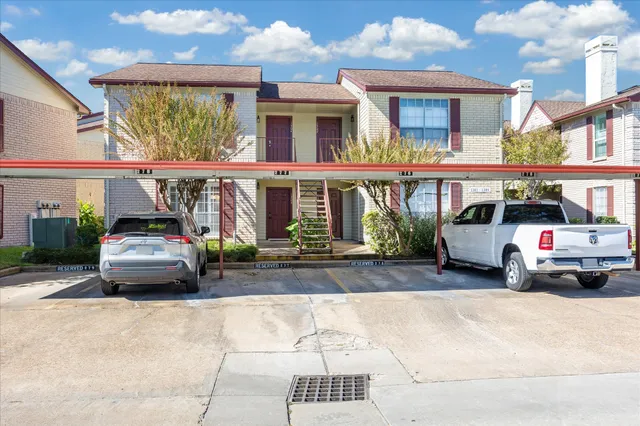 a view of a car parked in front of a house