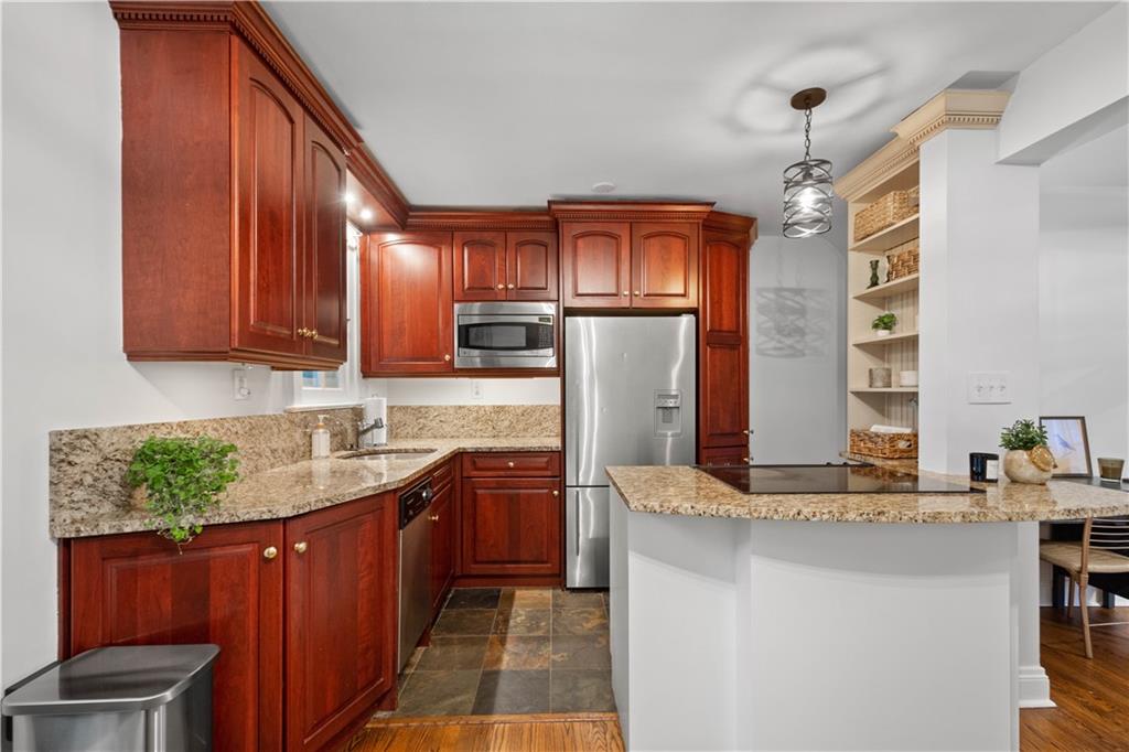 650 Pennridge Road Pittsburgh, PA 15211 - Photo 15 of 33 a kitchen with kitchen island granite countertop a sink stove and cabinets