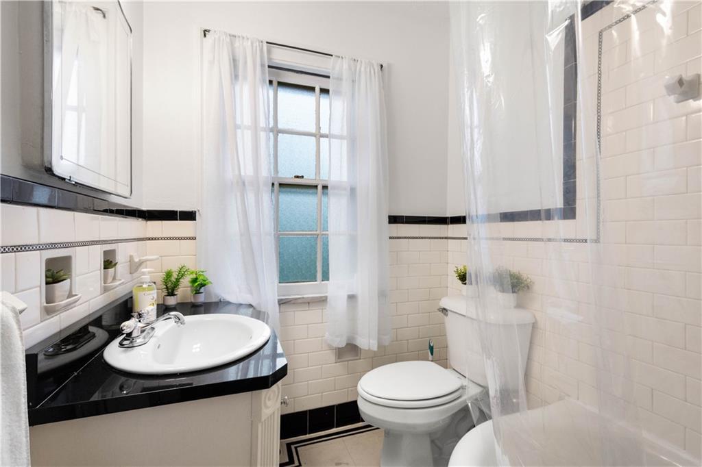 650 Pennridge Road Pittsburgh, PA 15211 - Photo 20 of 33 a bathroom with a sink toilet and mirror