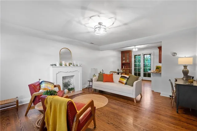 a living room with furniture a fireplace and wooden floor