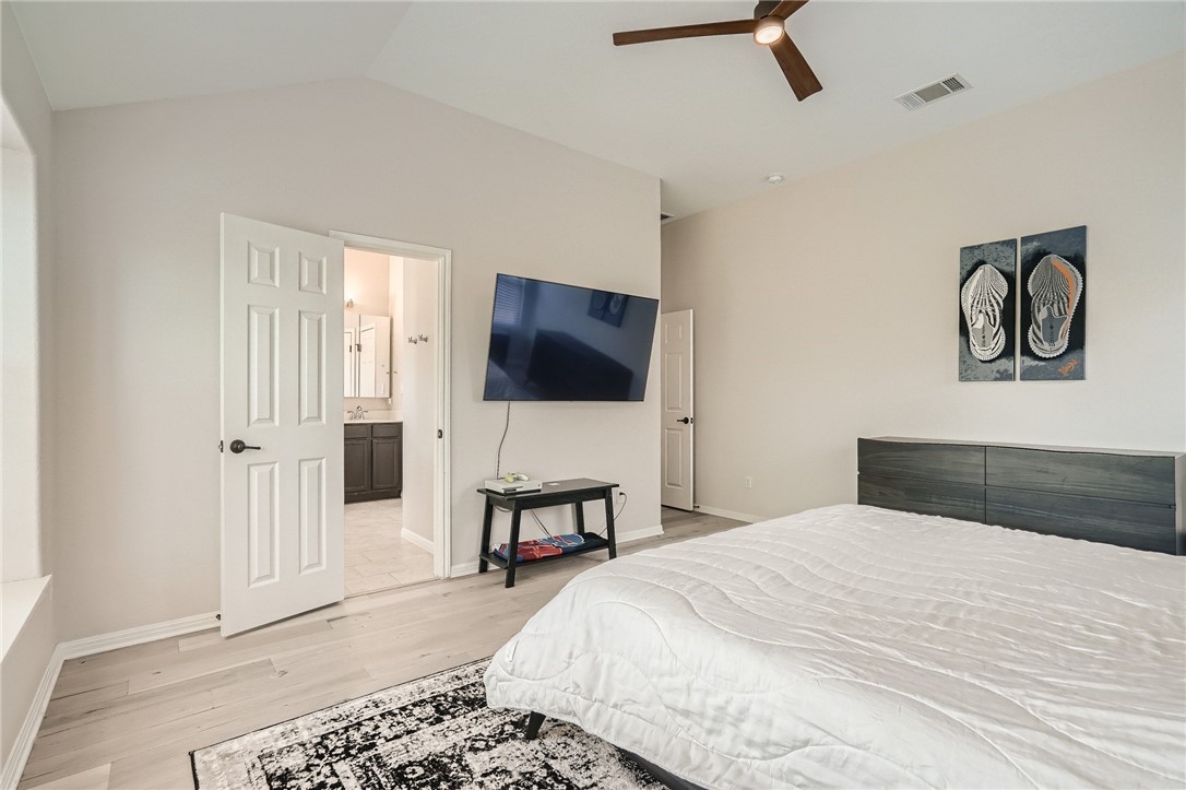 7108 Hester Road Austin, TX 78725 - Photo 7 of 25 a bedroom with a bed and a flat screen tv