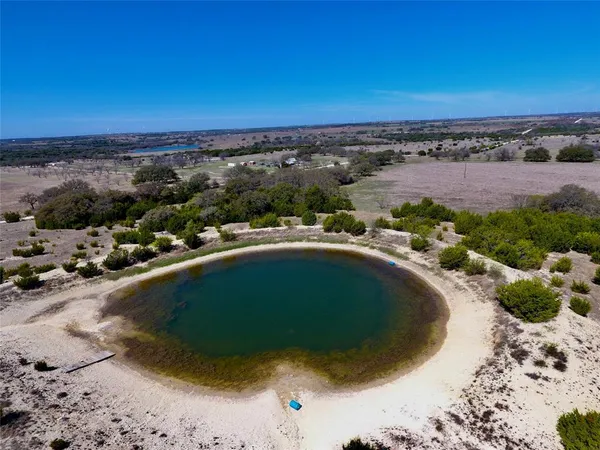 a view of a swimming pool with a yard