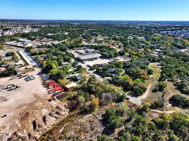 an aerial view of residential houses with city view
