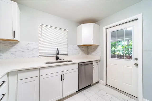 a kitchen with a sink and cabinets