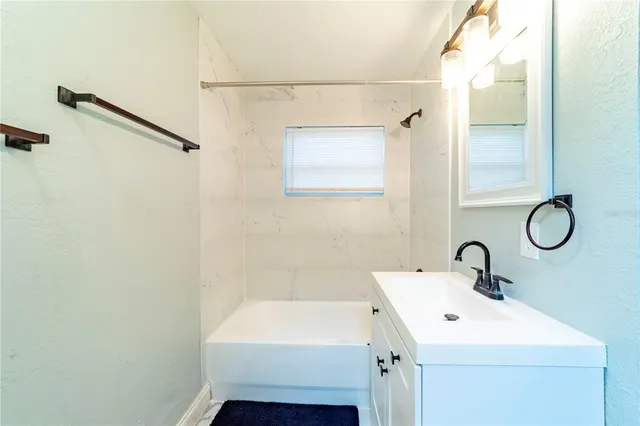 a bathroom with a sink and mirror