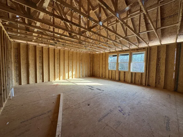 a view of a room with a chair and a window