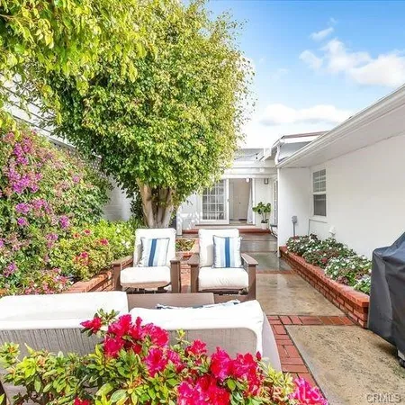 a view of a patio with table and chairs and potted plants