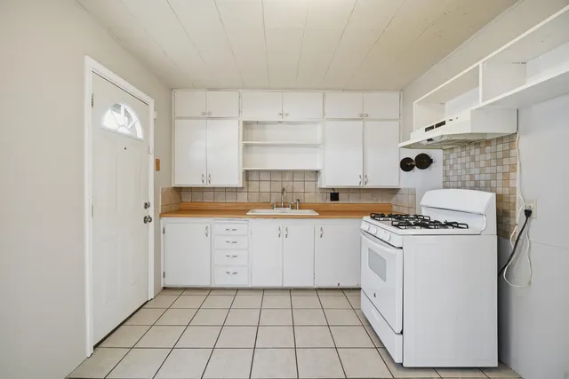a kitchen with a stove a sink and a refrigerator
