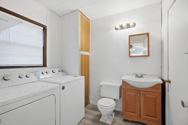 a bathroom with a sink toilet and a mirror