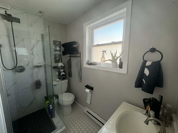 a bathroom with a toilet and a shower