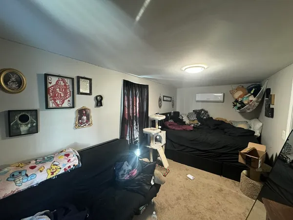 a living room with furniture stairs and a window