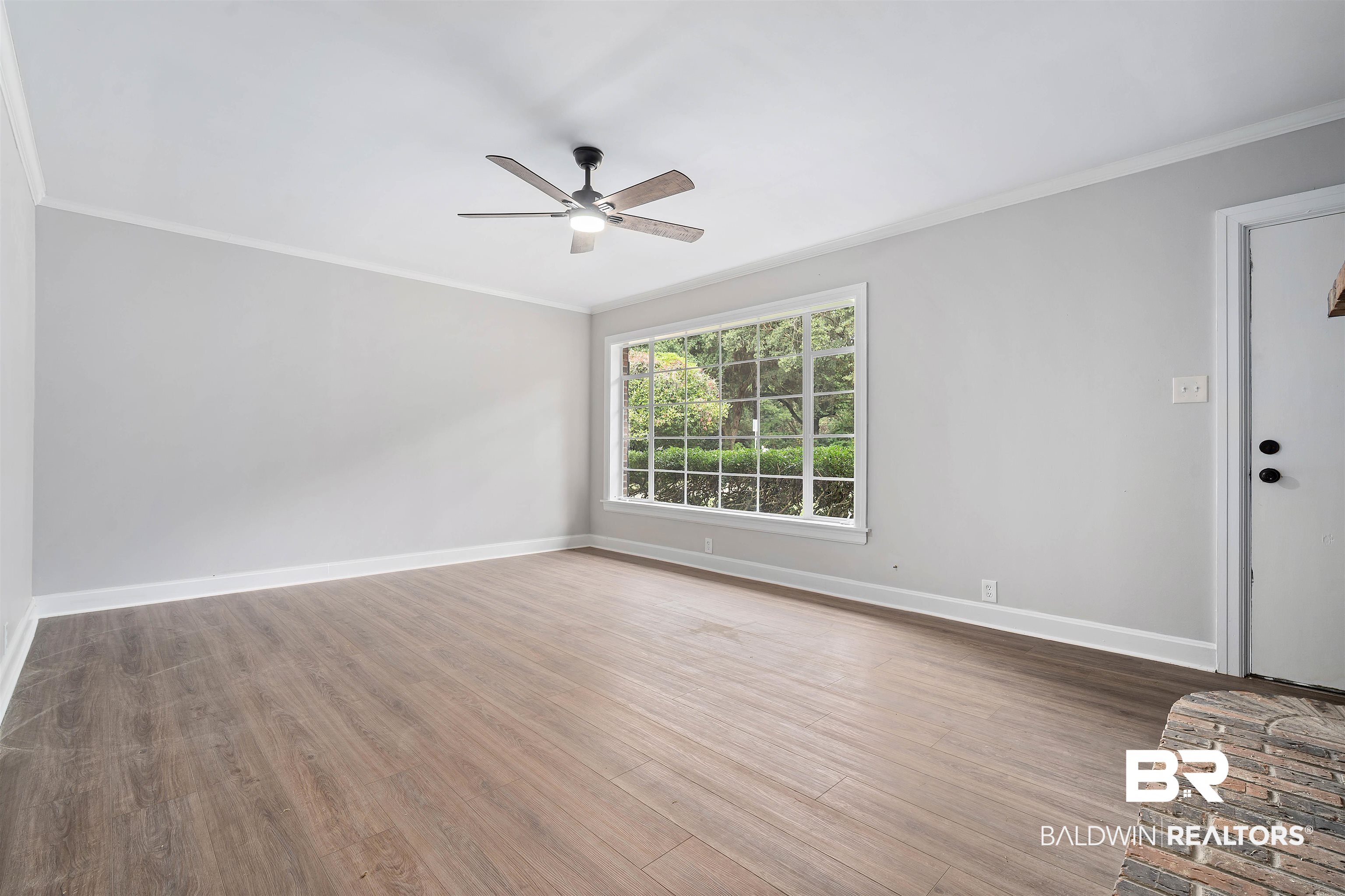 2261 Island Road Mobile, AL 36605 - Photo 6 of 25 Unfurnished room featuring ornamental molding, wood finished floors, and a ceiling fan