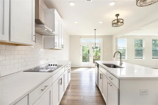 a kitchen with sink a stove and cabinets