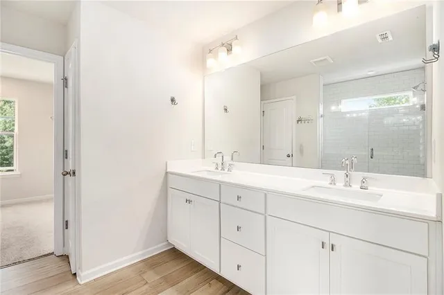 a bathroom with a double vanity sink mirror and double