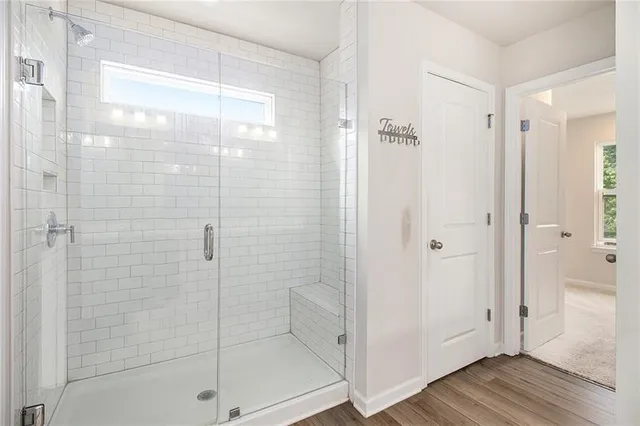 a bathroom with a glass shower door